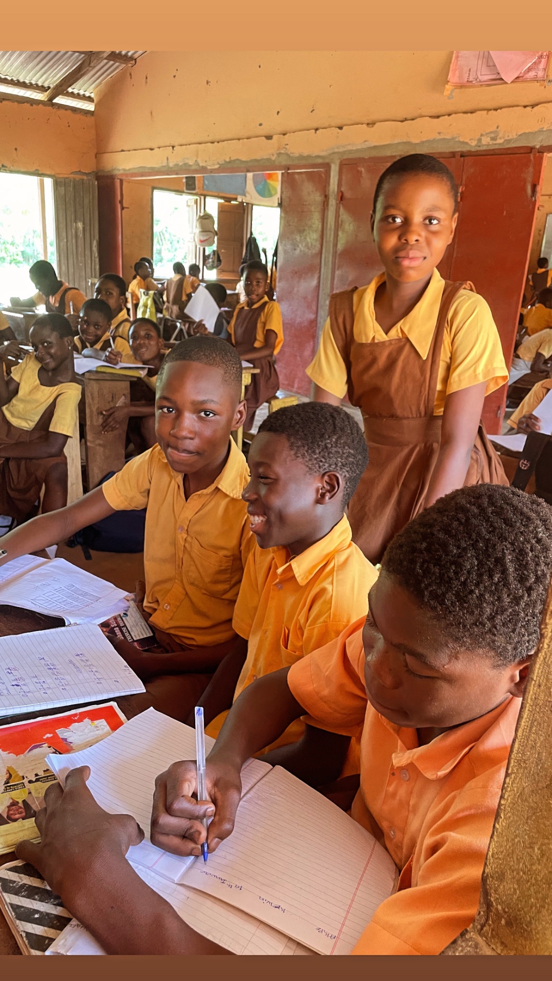 Children smiling and working in the classroom