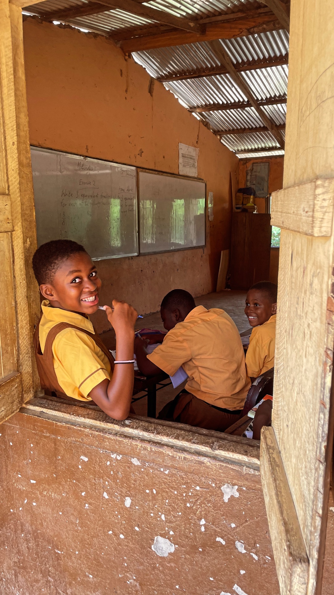 A smiling pupil in the classroom in Ghana